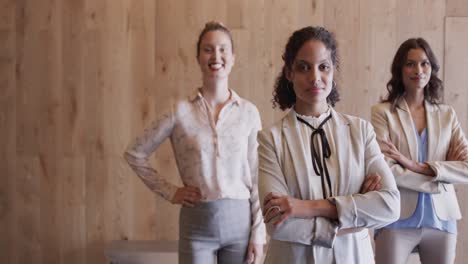 portrait of happy diverse female colleagues in office foyer, slow motion