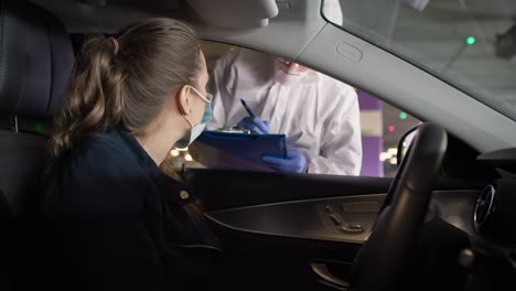 video of woman during coronavirus drive-thru pcr test procedure