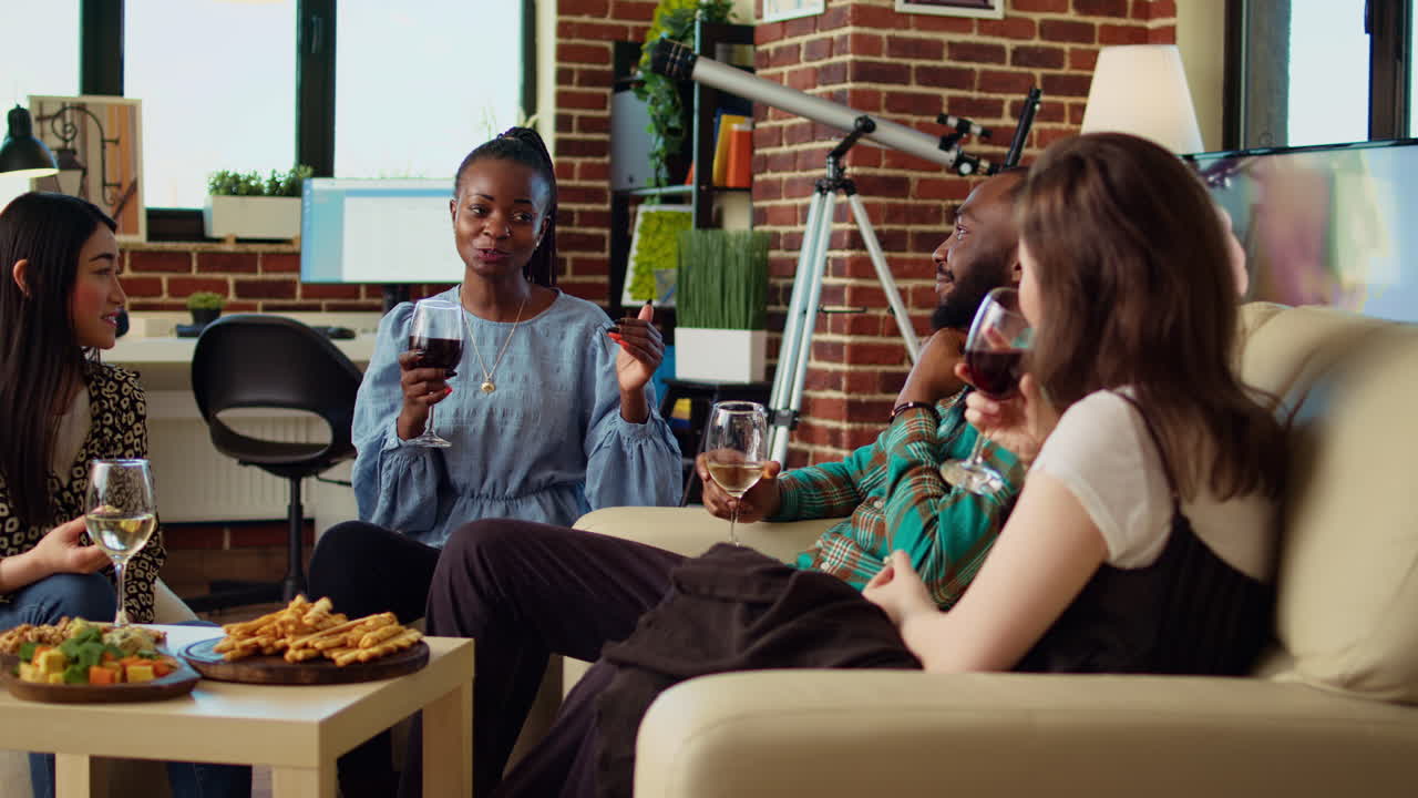 Woman telling story while friends enjoys tasty treats in brick wall living room