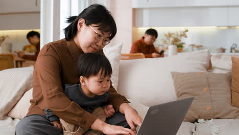 mother and child using laptop at home
