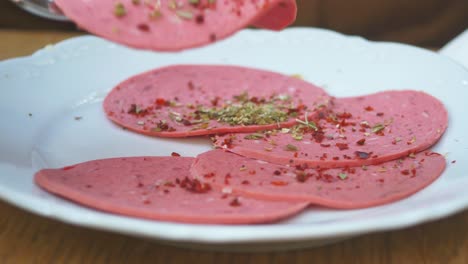 slices of pink sausage on a plate