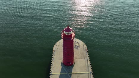 a painted red lighthouse baking in the summer sun