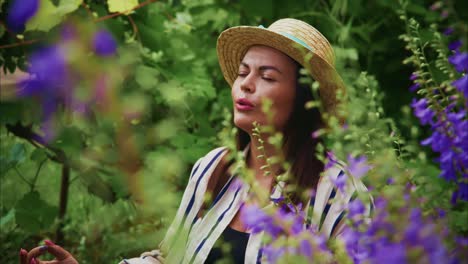 woman enjoying nature in a vibrant garden surrounded by colorful flowers and greenery