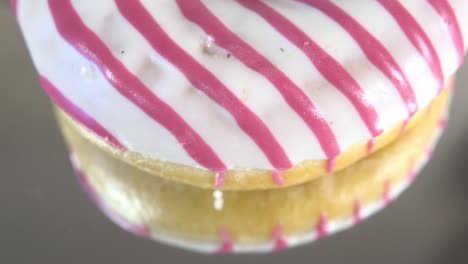 rotating donuts with different fillings on the mirror table. delicious sweet donut rotating on a plate. bright and colorful donut close-up macro shot spinning on a white background. seamless loop.