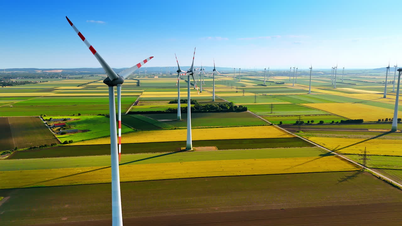 Turbines powering rural Europe. Wind turbines stand tall over expansive fields, harnessing renewable energy in a picturesque European landscape