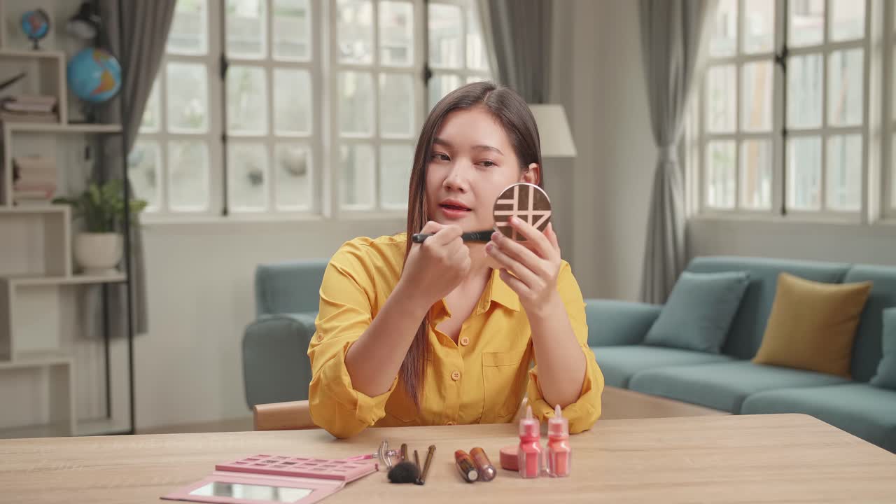 Beauty Blogger With Shadow Brush Talking To Camera, Makeup Tutorial Video At Home