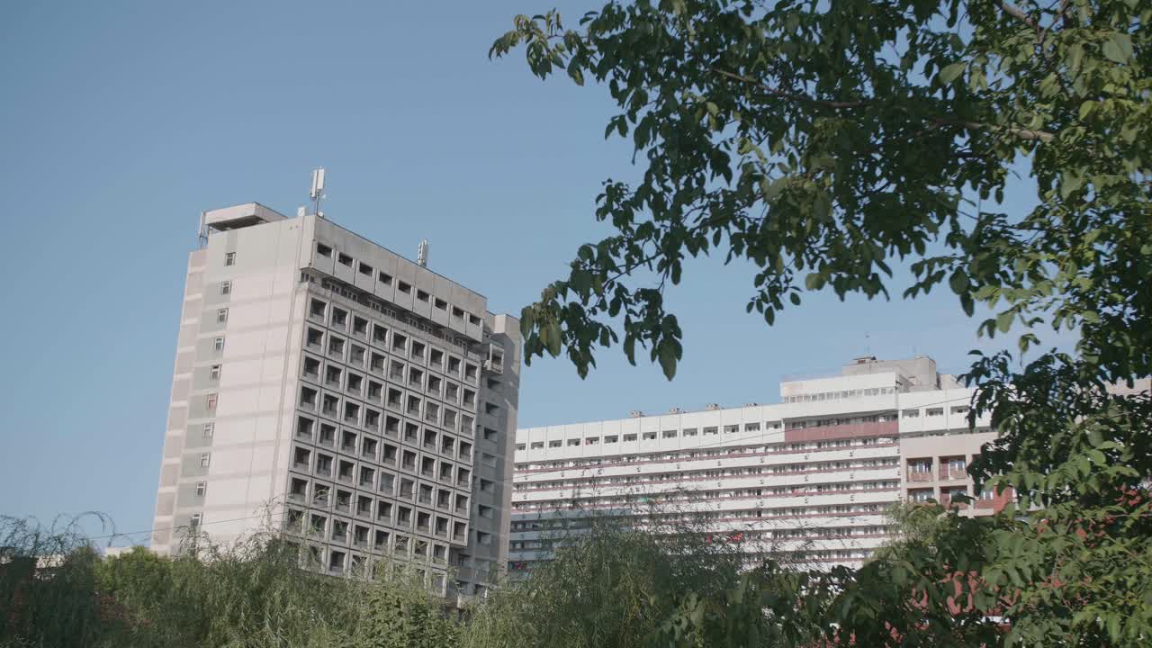 Static shot of an abandoned, derelict hotel in Băile Felix, Romania. The building is a stark example of communist-era brutalist architecture, left to decay in the popular spa resort.