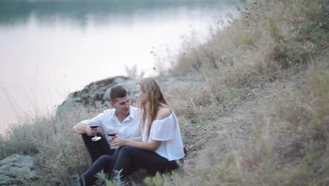 man giving an engagement ring to his woman in park