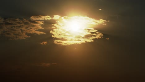 Lapso-De-Tiempo-Al-Atardecer-Con-El-Sol-Dorado-Detrás-De-Un-Paisaje-Nublado-Dinámico-Al-Atardecer