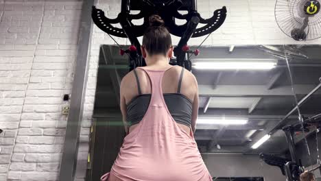 close-up shot of caucasian female athlete pulling up crossbar