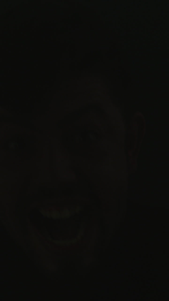 Close-up of Man's Scary Laughing Face Revealed by Flash