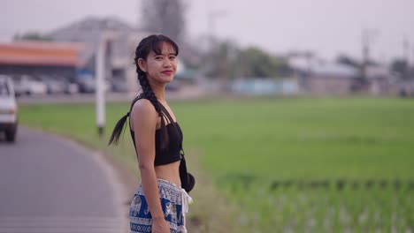 young asian woman with braids in a rural landscape