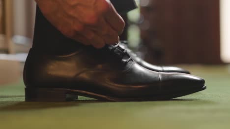 portrait of elegant shoes and belts on a shelf of a shop (tailoring).