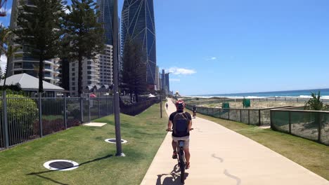 person riding a scooter along a coastal pathway