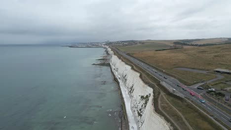 aerial flight along tall, steep white chalk cliffs of english seashore