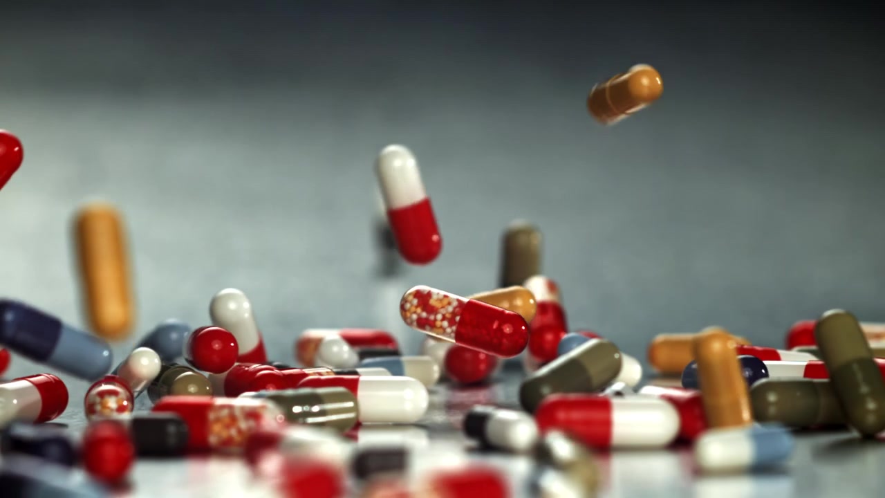Pillole e capsule colorate che cadono al rallentatore