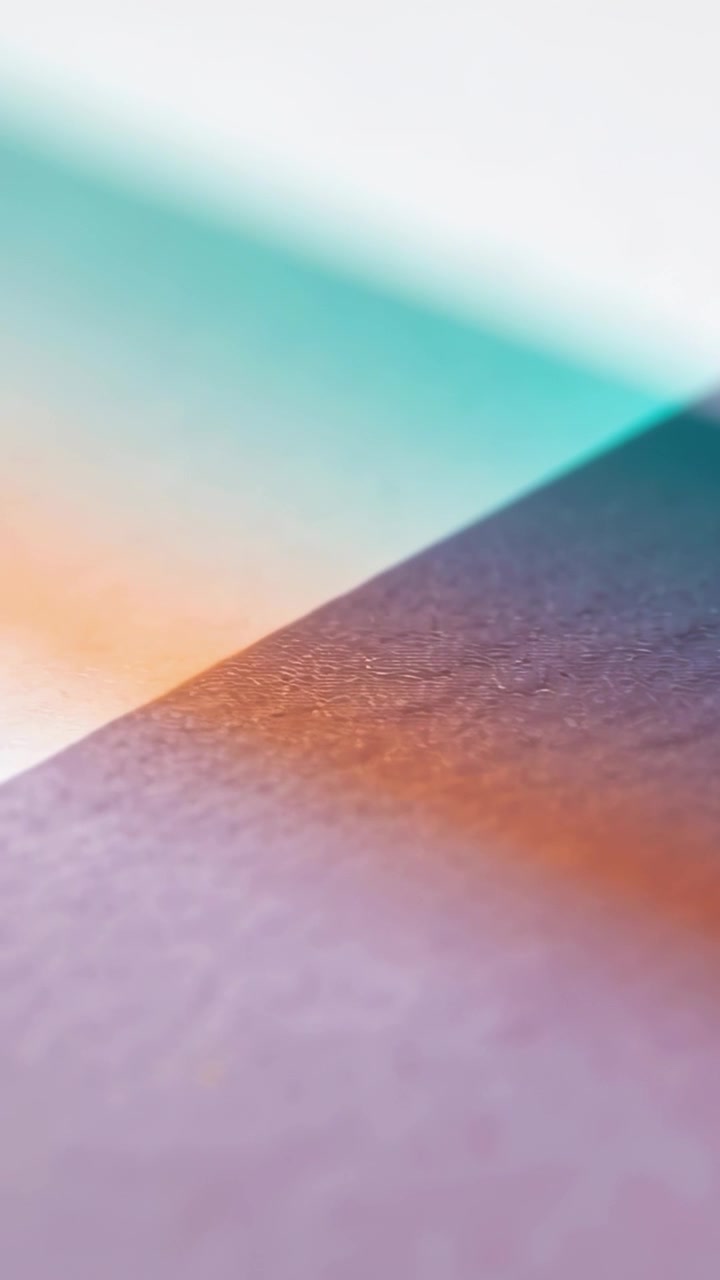 Vertical video: Showing textured panel as focus shifting and lights warming in studio showing grain