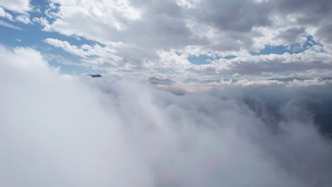 aerial flying towards white clouds