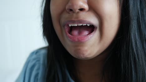 close up of a woman's mouth while speaking.