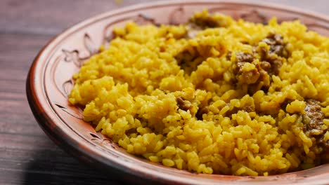 boiled yellow rice with meats on a plate