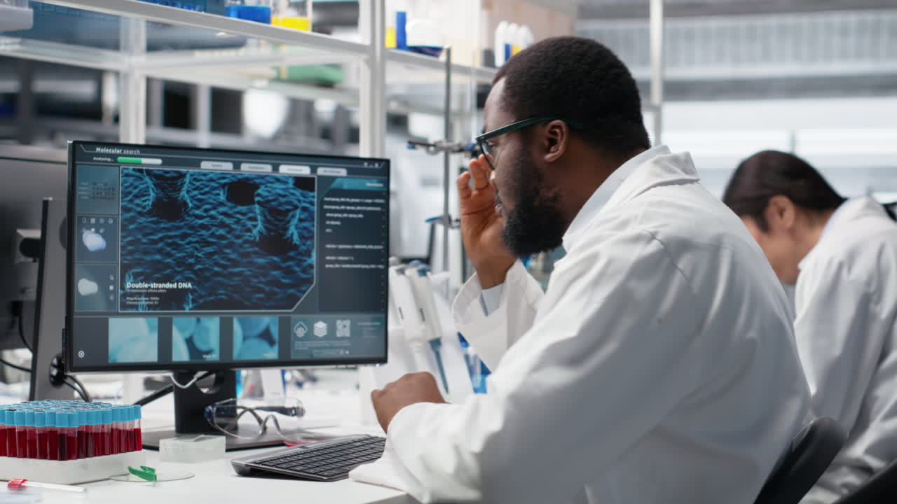 Vertical video Molecular biologist uses computer displaying DNA data, removing eyeglasses