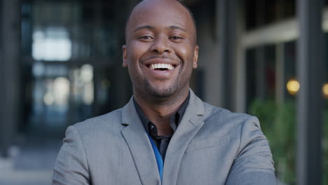portrait young happy african american businessman smiling arms crossed enjoying professional urban lifestyle in city ambitious black entrepreneur looking confident