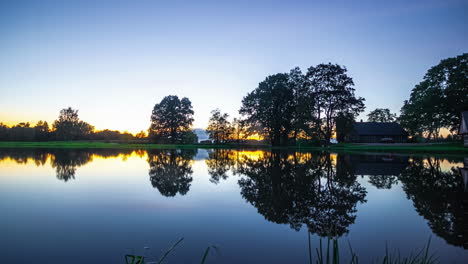 Reflections-Over-Calm-Lake-On-A-Misty-Sunrise-And-Frozen-Winter-Season