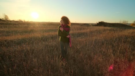 woman enjoying the sunset in a field