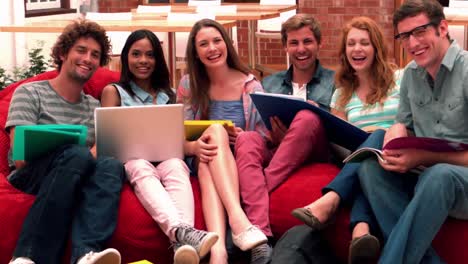 Happy-students-smiling-at-camera-in-common-room