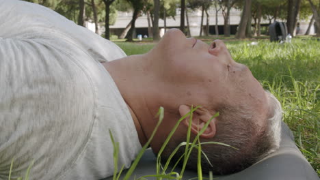 Old-caucasian-man-meditates-in-the-park