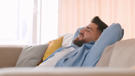 man relaxing comfortably on a couch