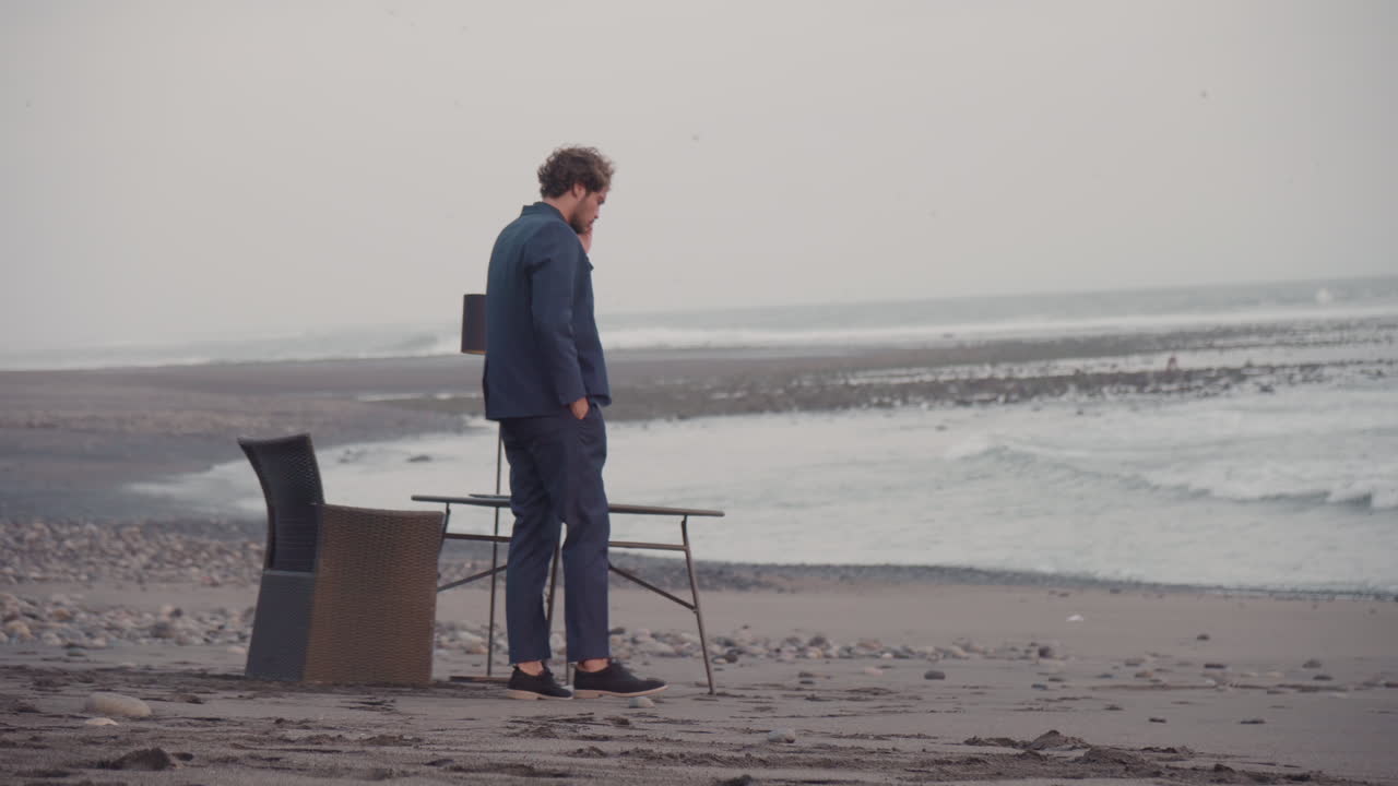 Man Talking On Phone On Isolated Beach