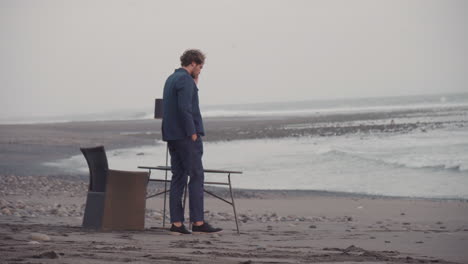 man talking on phone on isolated beach