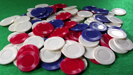 a pile of poker chips on a green felt table