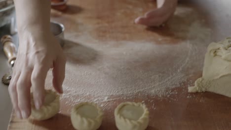 baking traditional sardinian panadas rolling dough with hands close