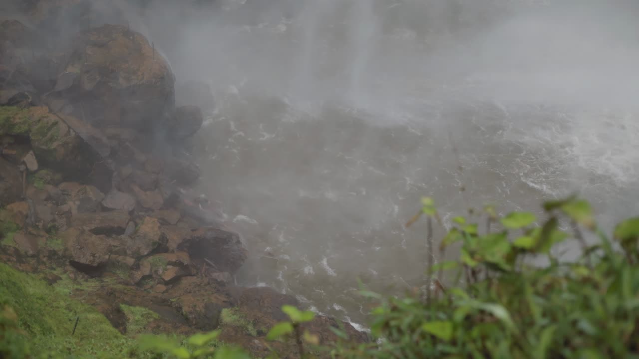 Super slow motion shot of water flow and spray from large waterfall