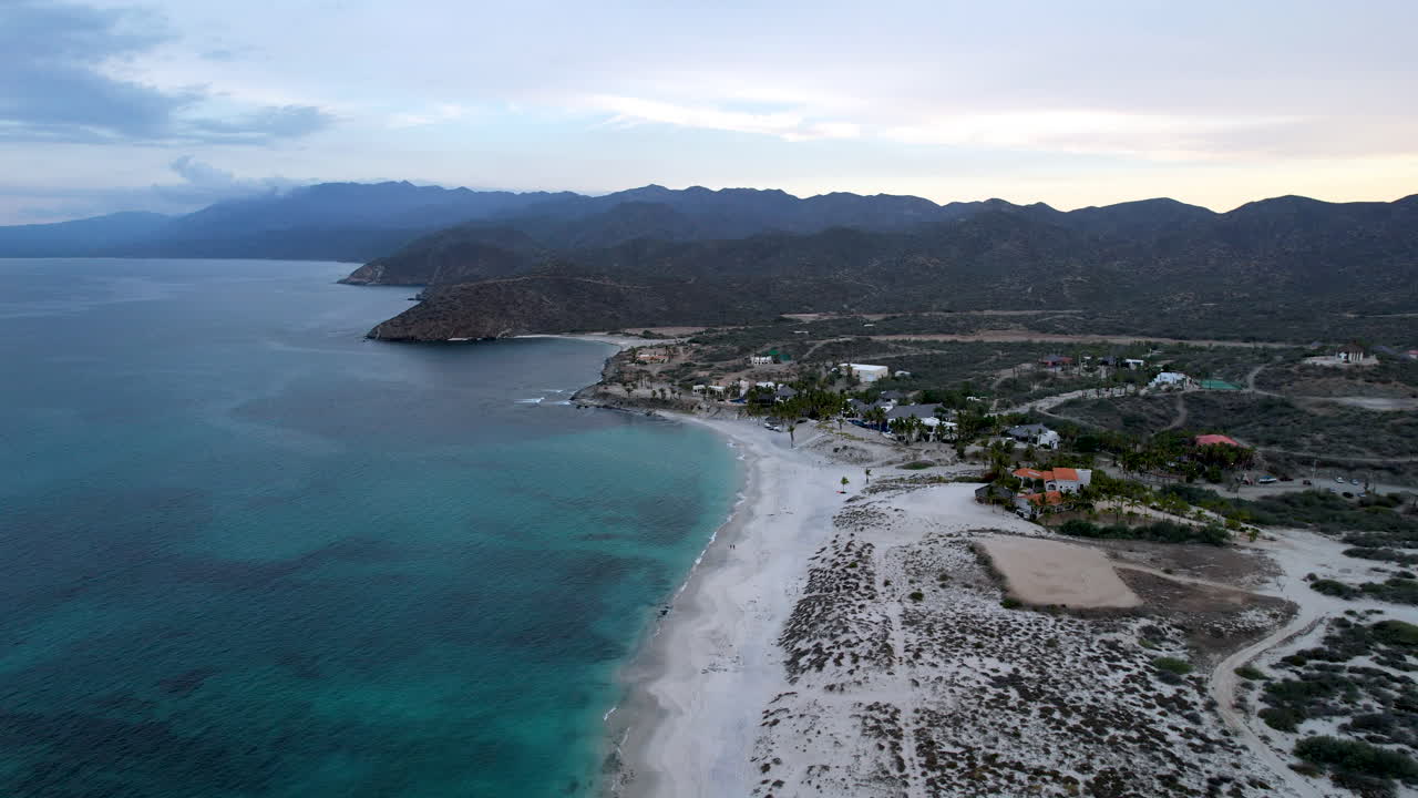 Drone shot in reverse of the bay of Baja California Sur and the hotels on the beach line