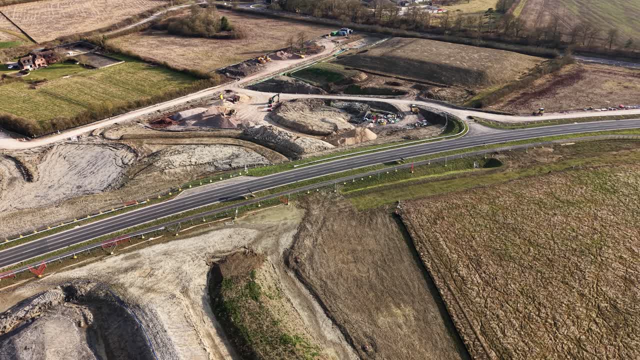 Aerial view of active construction site, A41 in Waddesdon, UK, earthmoving machinery and excavation work