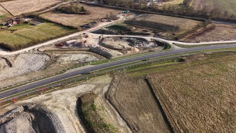aerial view of active construction site, a41 in waddesdon, uk, earthmoving machinery and excavation work