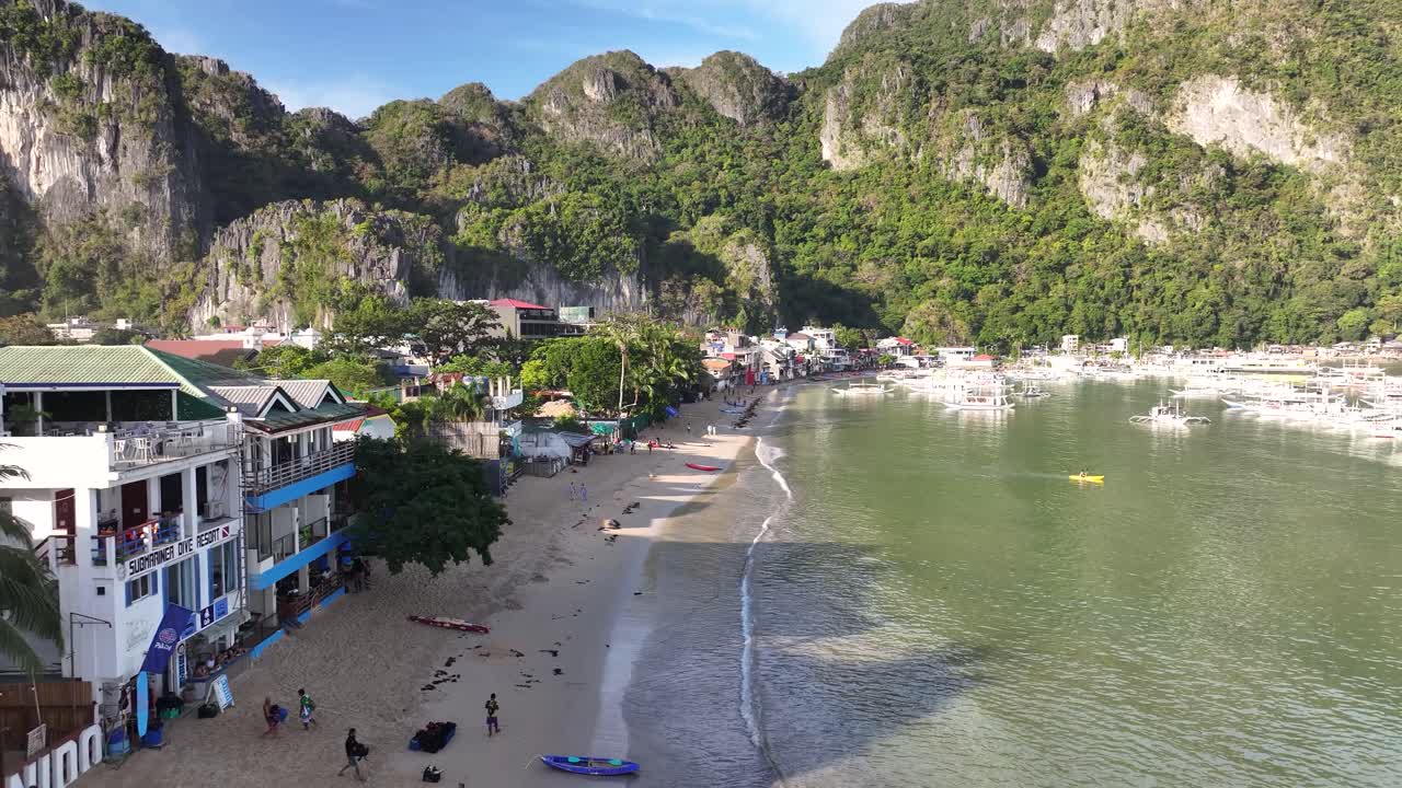 Picturesque morning at El Nido beach with hotels and restaurant, famous tourist destination. Aerial