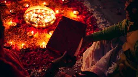 couple celebrate a colorful diwali rangoli- red pink orange green