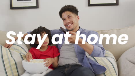 animation of stay at home text over african american man and his son