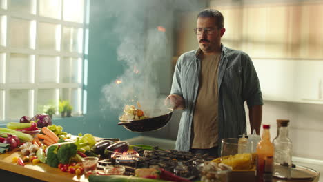 man cooking, kitchen fire