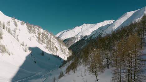 aerial: skiers on austrian alps mountain valley ski resort, silvretta