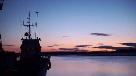 fishing boat at sunset on a river