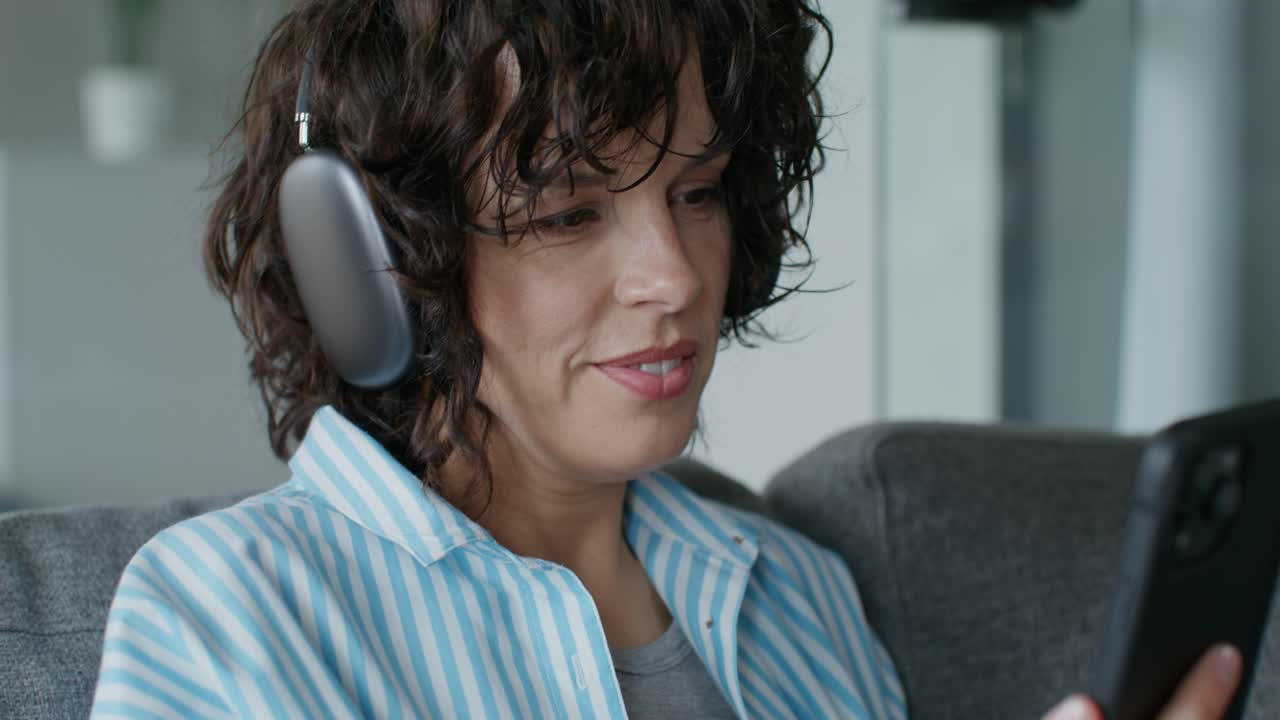 mujer usando teléfono y auriculares