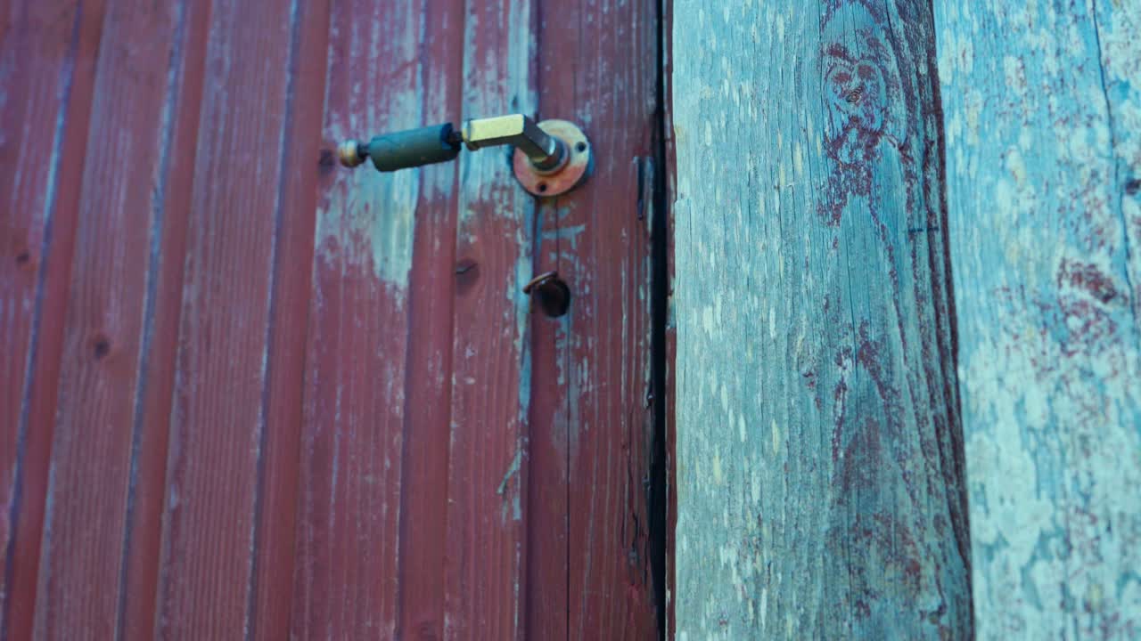 Hand Of A Person Opening Vintage Key Of A Wooden Chalet