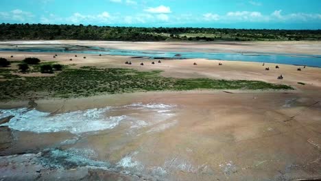 Riders-On-Motorcycles-Around-Lake-Magadi-In-Kenya---aerial-drone-shot