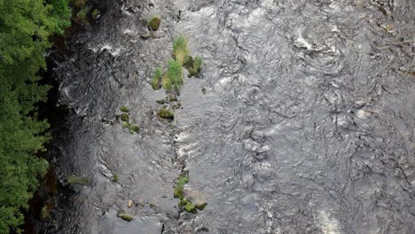 Overlooking-woodland-river-gorge-wilderness-flowing-water-scenic-stream