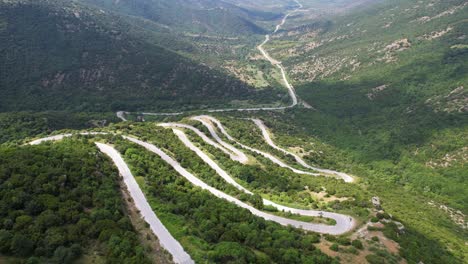 serpentine road in olympus mountain greece, aerial drone view of mountain road winding, scenic route